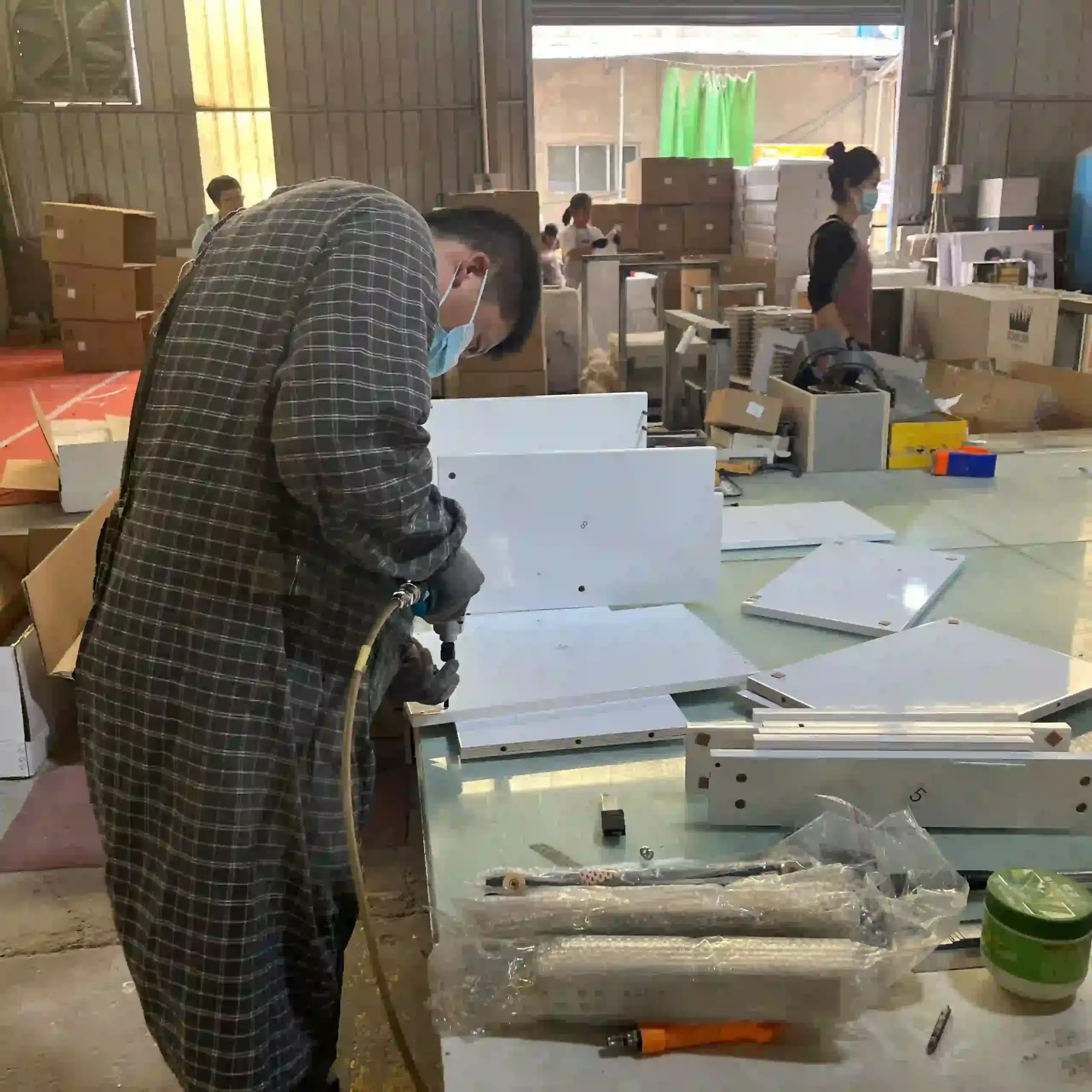 Verifying Certification Claims: What a Real ISO 9001 Factory Audit Looks Like 3 workers assembling bathroom vanity cabinets on the factory assembly line
