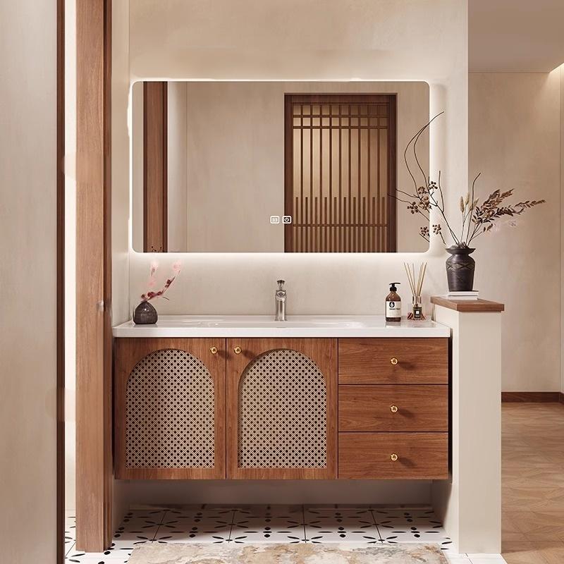Oak vanity with a matte sintered stone countertop and integrated basin in warm white