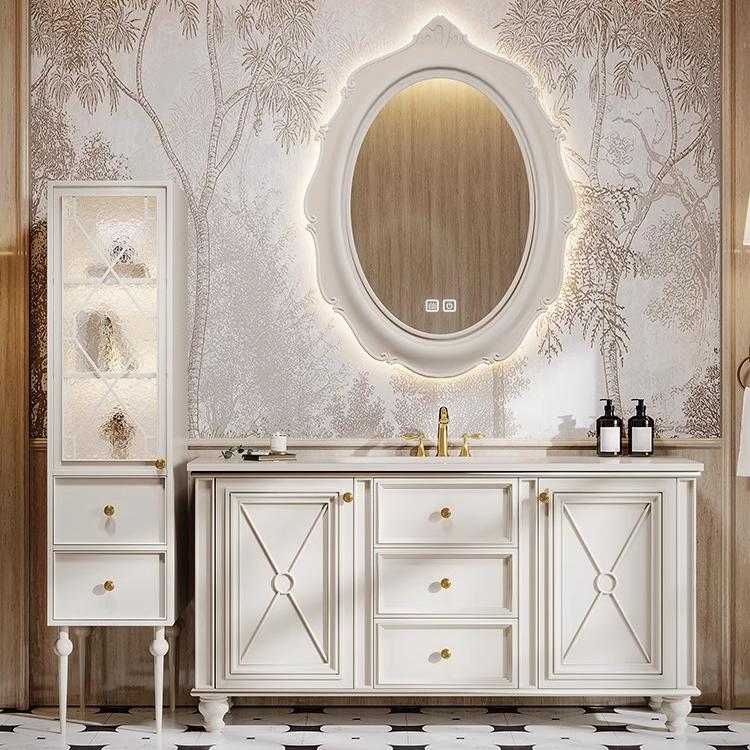 Solid oak bathroom vanity with warm white doors and a sintered stone countertop